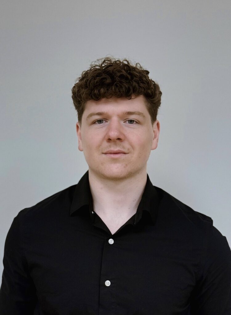 headshot of chase in a black button up