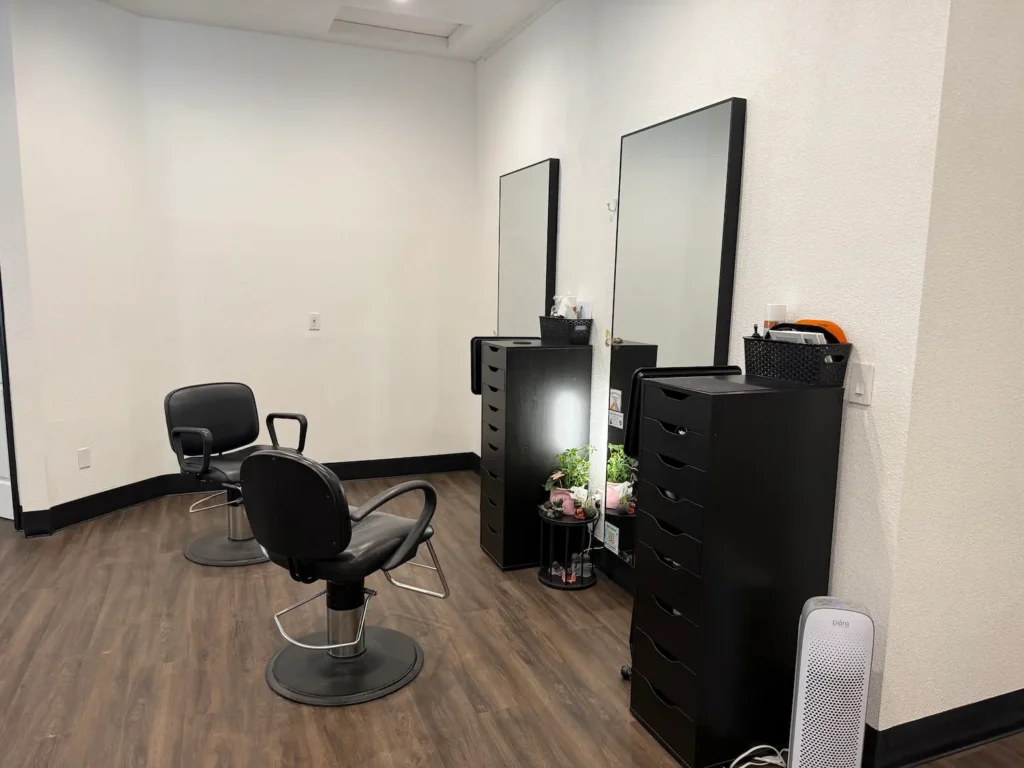 two empty chairs inside a hair salon